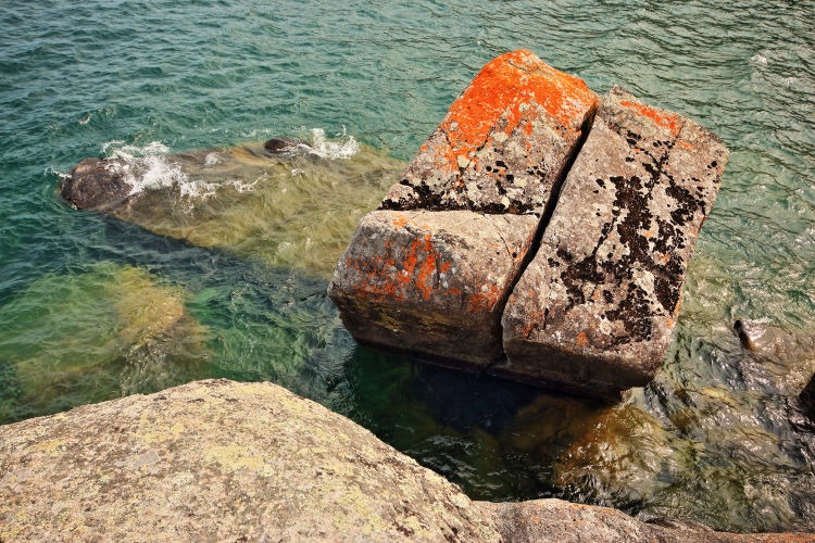 Seascape photograph of a minimalist composition of rocks and water