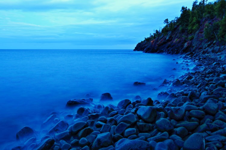 Seascape photograph of a moody cobble beach on the North Shore of Lake Superior