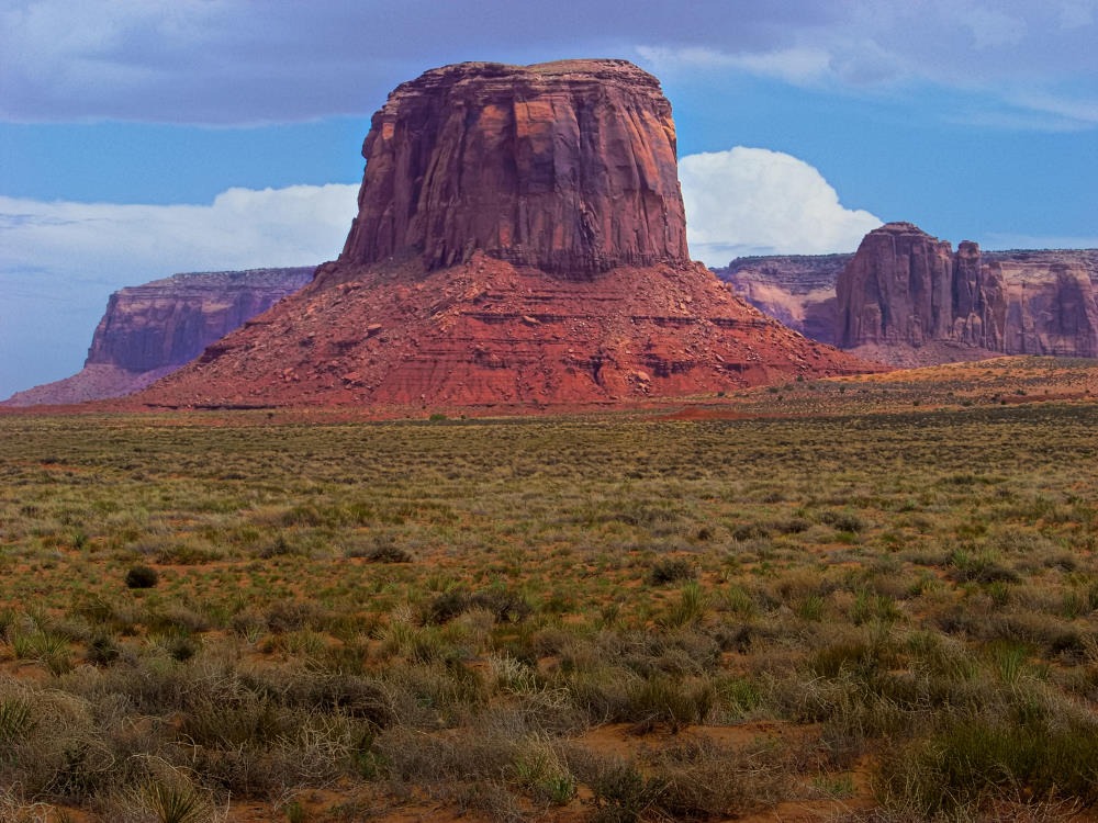 A nice daytime view of Mitchell Butte in Monument National Park. The side lighting from the right throws the structure of the butte into high relief.