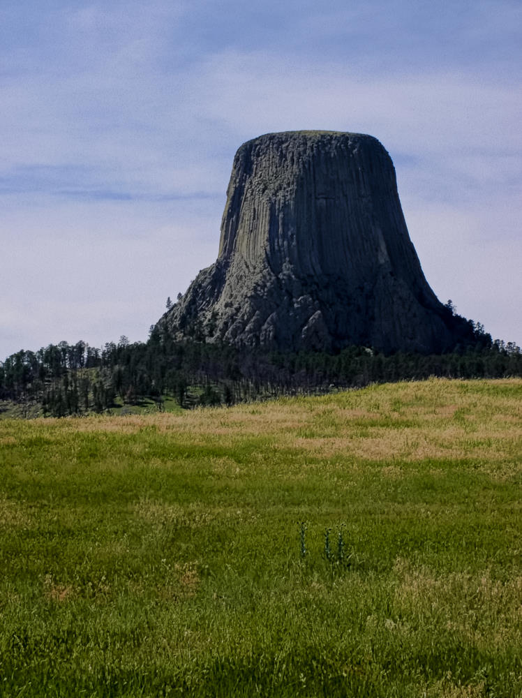 Devil's Tower in Wyoming, side lit from the left. The side lighting adds definition to the basalt columns.